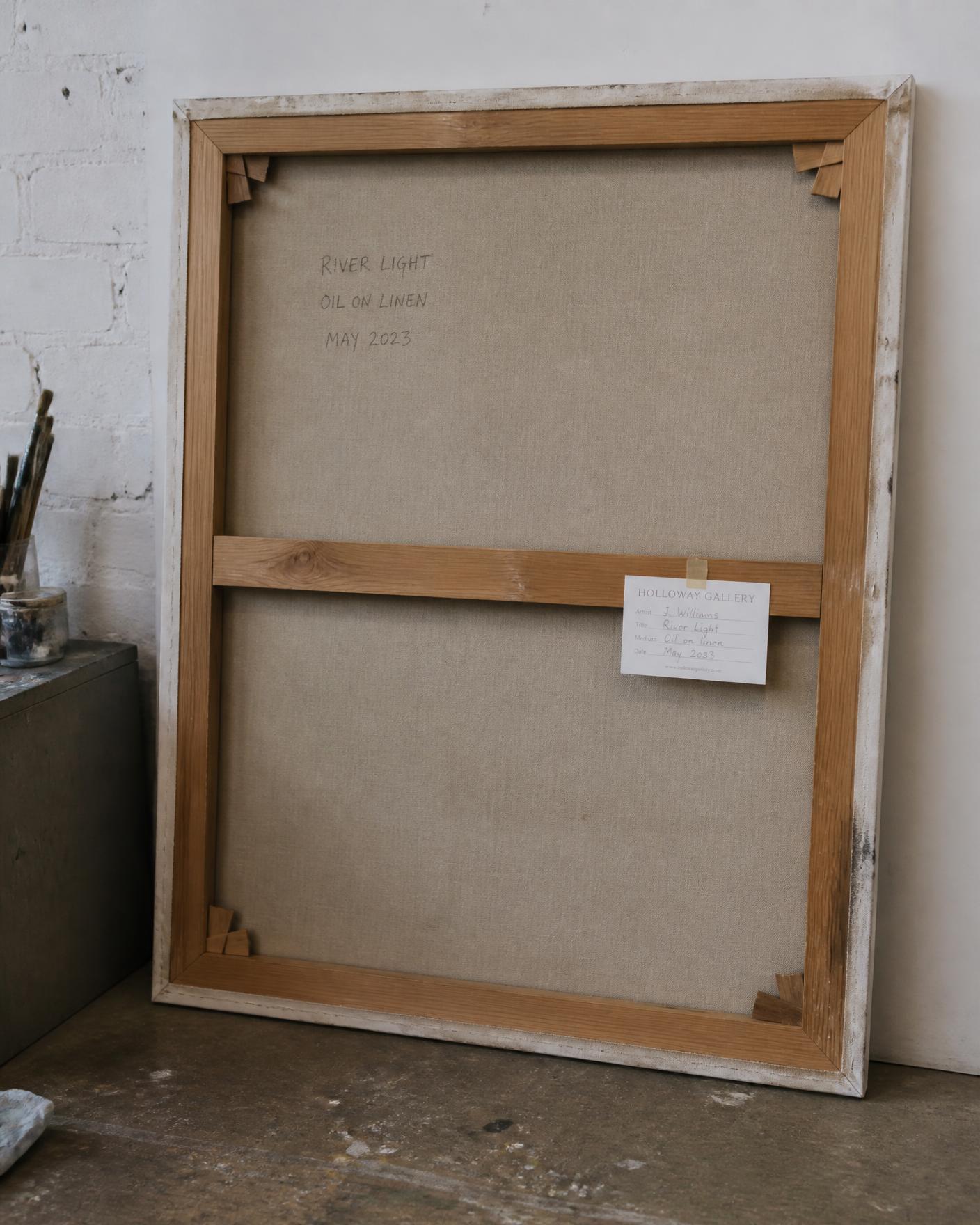 Reverse of a stretched canvas painting in storage with stretcher, inscription and gallery label